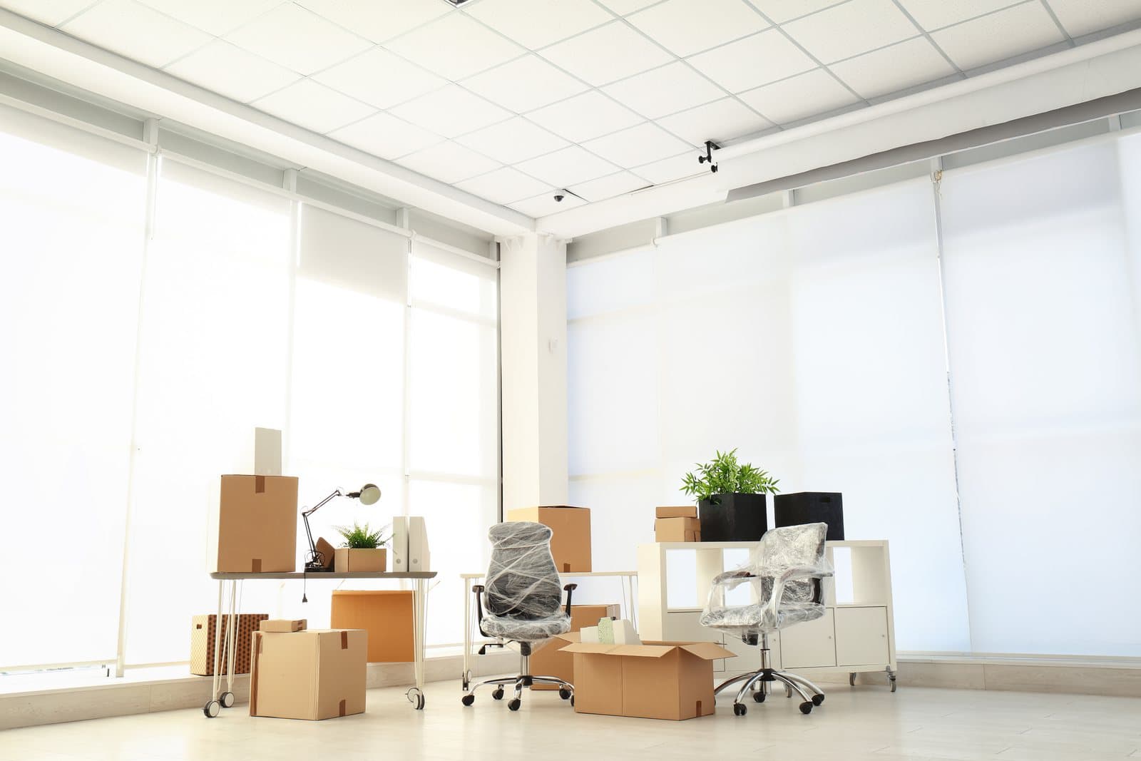 Packed office furniture and moving boxes prepared for an employee relocation
